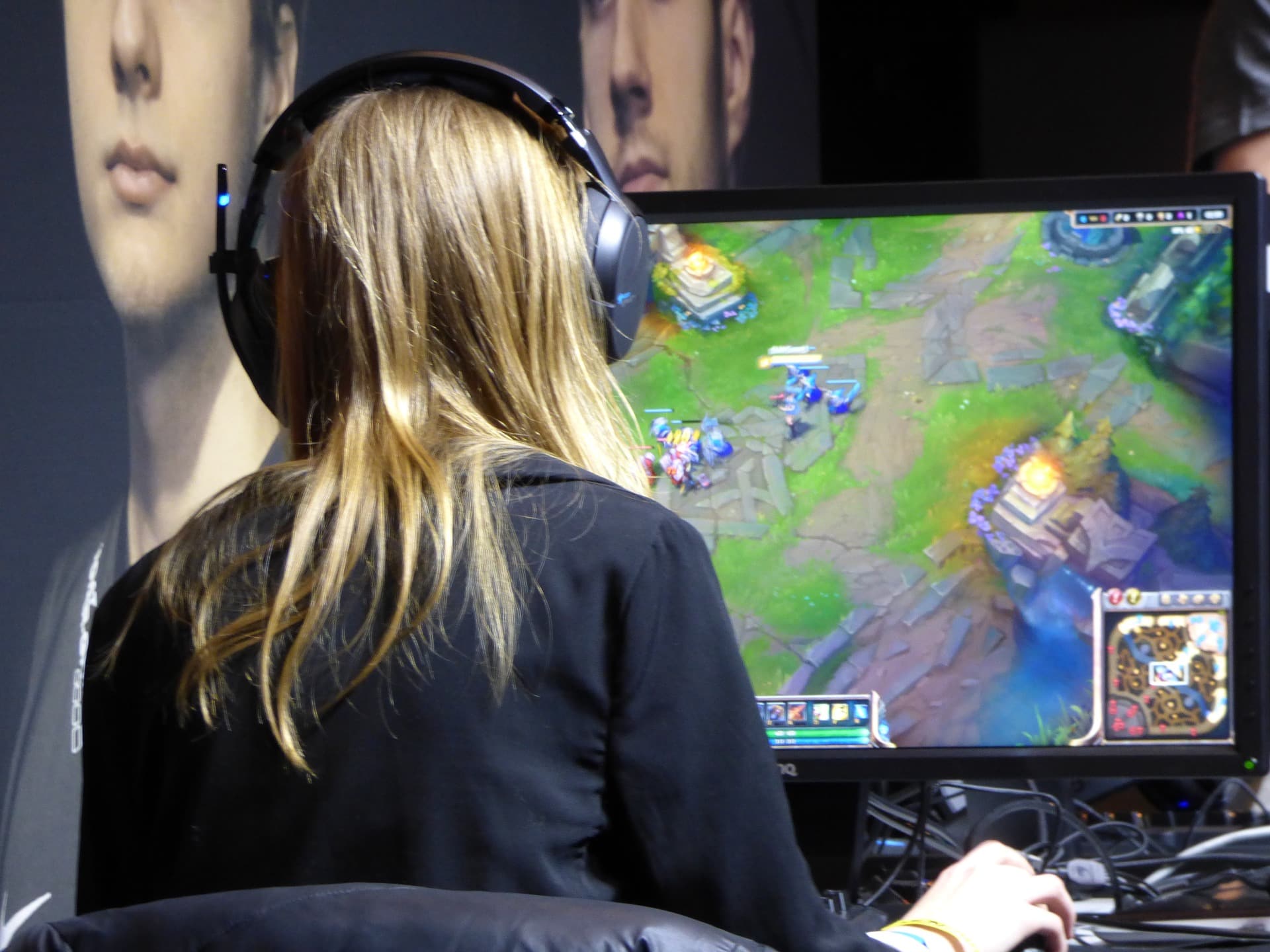 blonde gamer playing computer game on gaming computer